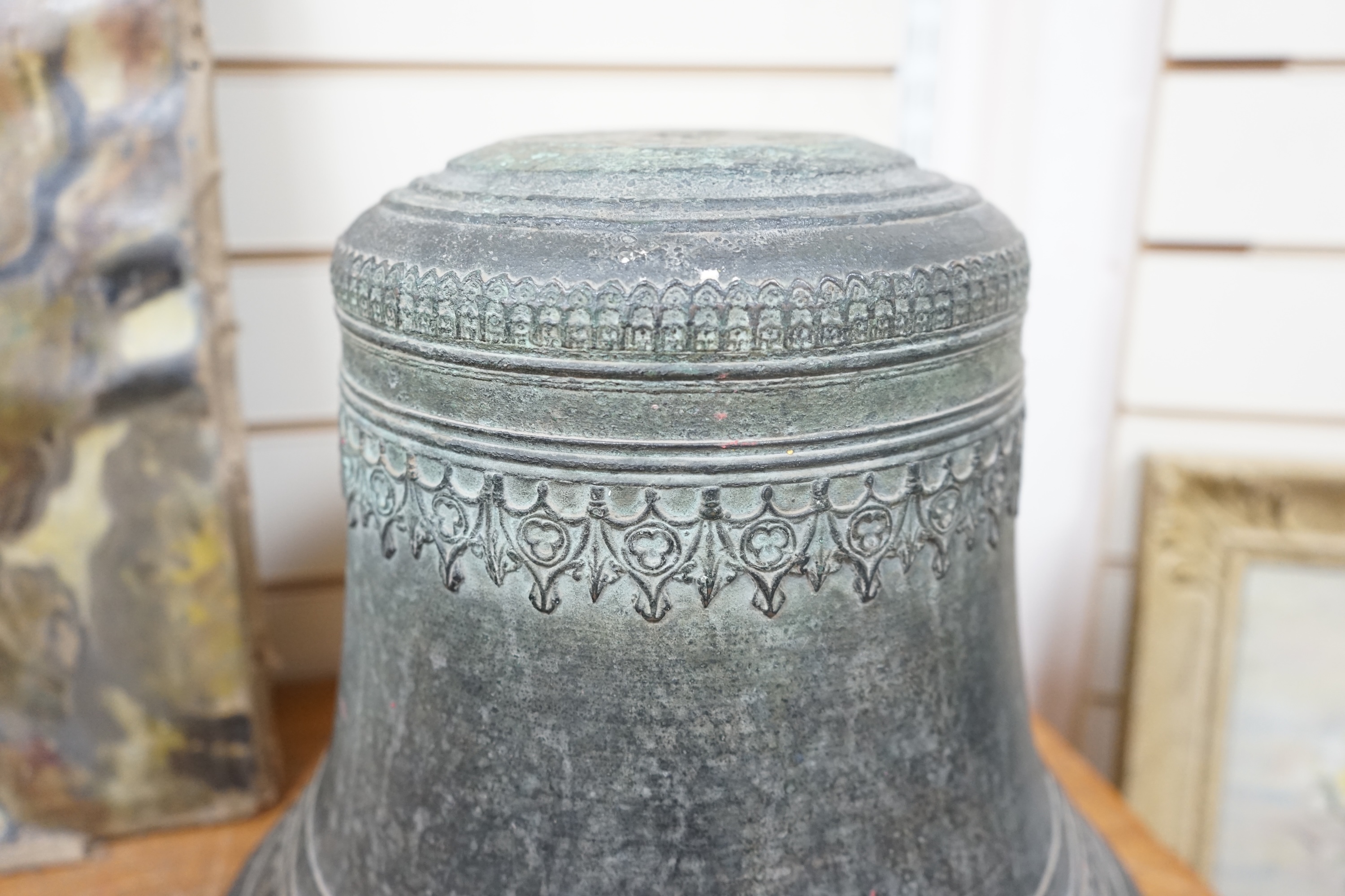 A large Dutch or French cast church bell, 17th/18th century, with decorative Gothic frieze, 33cm high, 40cm diameter. Condition - fair, the crown has been ground off the top.